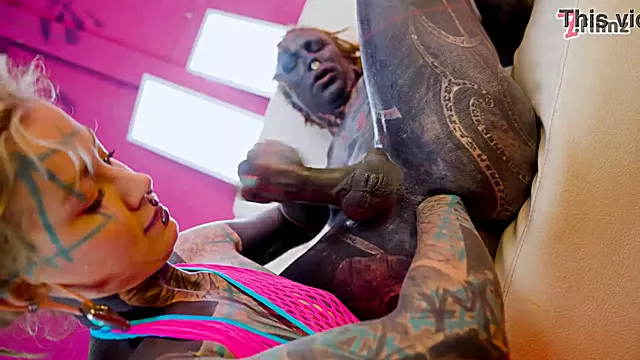 Tattooed dominatrix in pink Fishnet