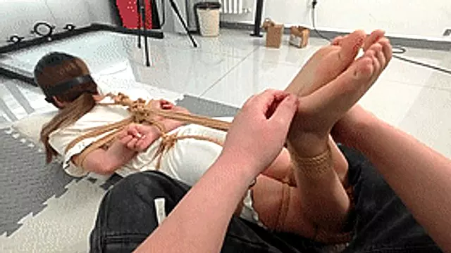 xy353 - A cute barefoot girl is bound by ropes and has her feet tickled.