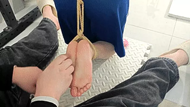 xy350 - Barefoot girl with her neck and hands bound by metal, her feet suspended and tickled.