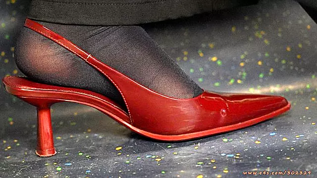 Amazing nylon feet with sexy red high heel pointed sandals, foot fetish ignoring and admiration close-up.