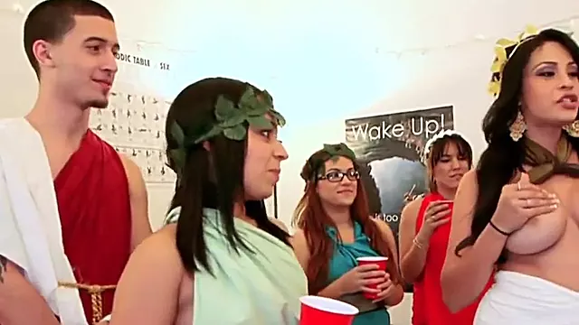 Blindfolded lad licks ass at a femdom toga party