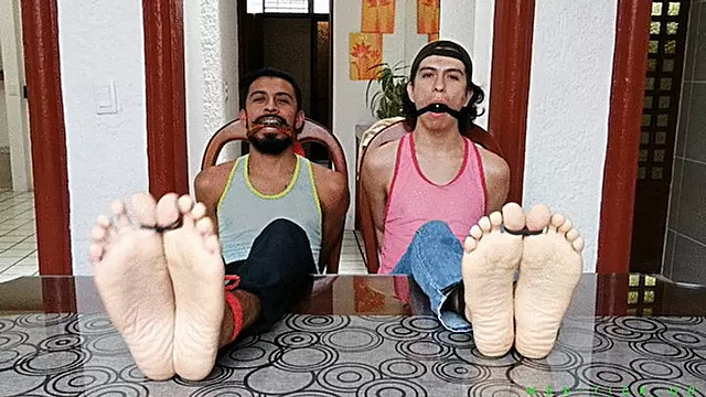College Boys Andrade & Giovinco Are Getting Humiliated With Merciless Foot Tickling By Master Jose. He's Testing Various Mean Tickle Tools Such As Hairbrushs On The Boys Sensitive Feet. To Humiliate Them Even More He Also Gagged The Two Boys.