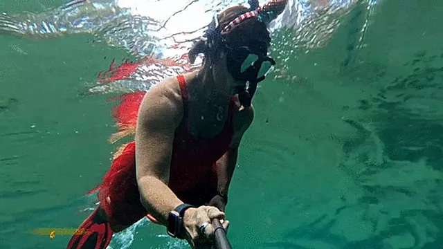 Carissa snorkeling in her Christmas outfit with exposure part two