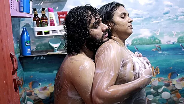 Chesty brunette getting wet in the shower with her man