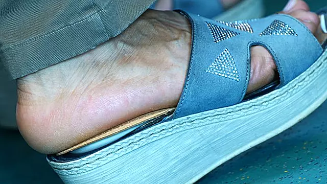 Candid sandals and foot fetish watching close-up, hot foot heels, the feet move continuously in an attractive way
