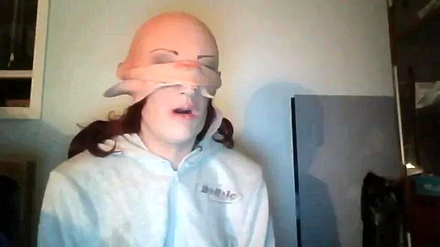 Redhead rubber mask unmasking her Greyland Playmate fantasy