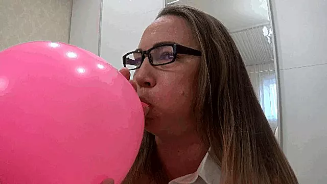 Inflating a large balloon until it explodes b