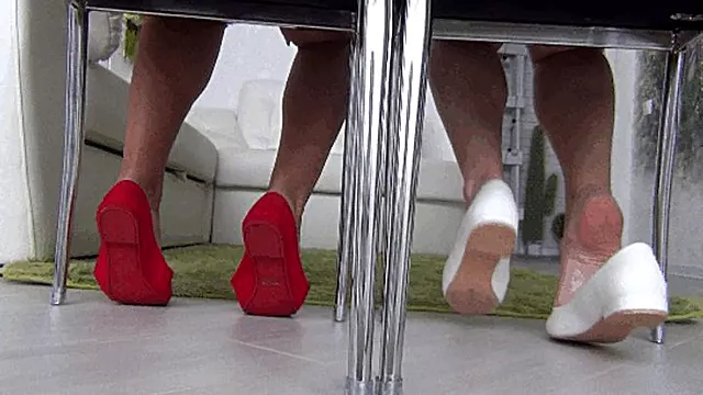 Playing with ballet shoes under a chair d
