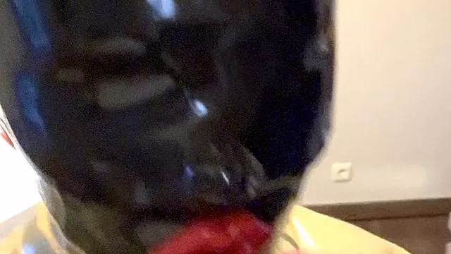 Rubbermissy selfenjoyment of a black Rubberdoll with blindfold and gag in full latex catsuit