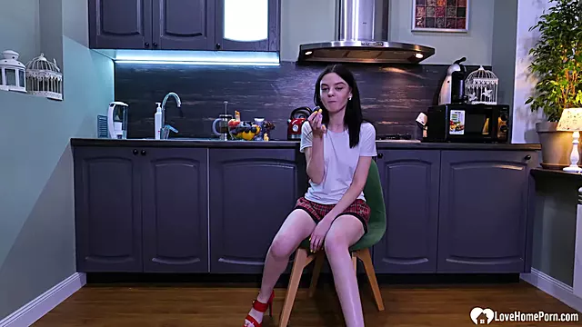 Schoolgirl goes for a solo in the kitchen